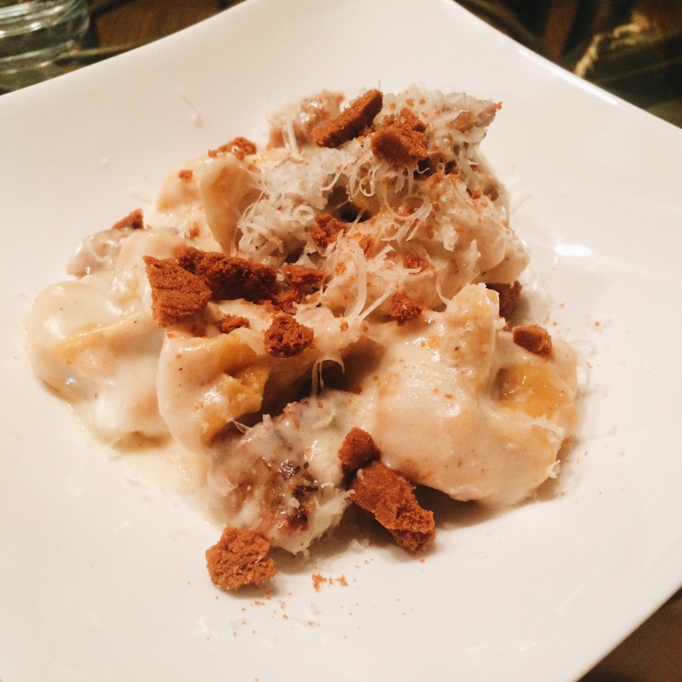 Pumpkin Sacchetti Pasta with crumbled sausage and a bechamel sauce with crumbled amaretti